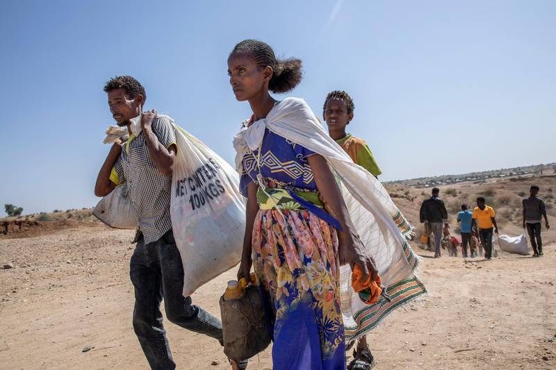 Tigray refugees who fled the conflict in the Ethiopia's Tigray walk to Hamdeyat Transition Center after arriving on the banks of the Tekeze River on the Sudan-Ethiopia border, in Hamdayet, eastern Sudan. AP Photo