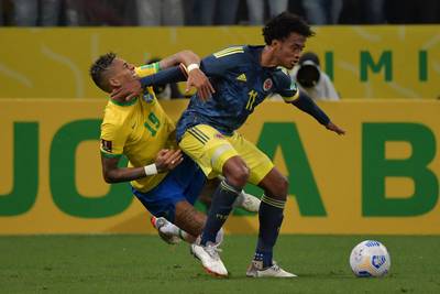 Brazil's Raphinha and Colombia's Juan Cuadrado vie for the ball. AFP