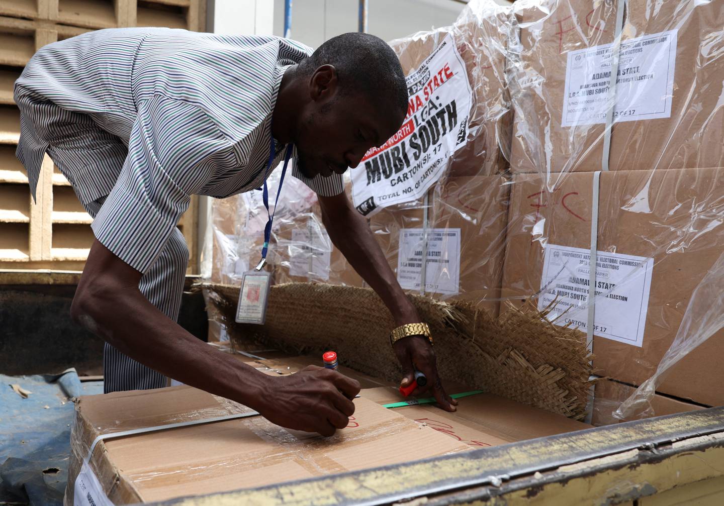 An official marks boxes of voting materials in Yola. Reuters