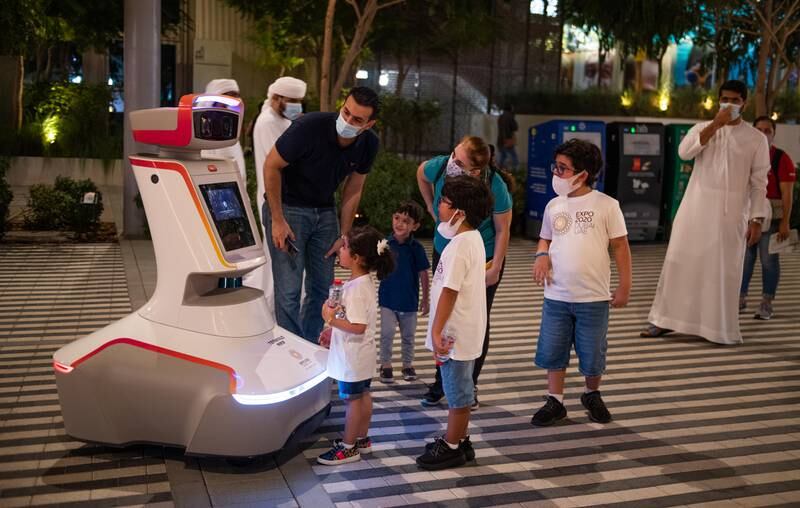 Visitors interacting with one of the robots at Expo. Image: Expo 2020 Dubai