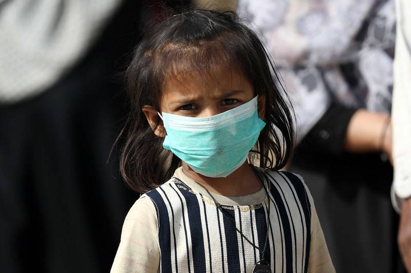 A child wears a protective face mask after cases of novel coronavirus were reported in the country and neighboring Afghanistan and Iran, in Karachi, Pakistan.  EPA