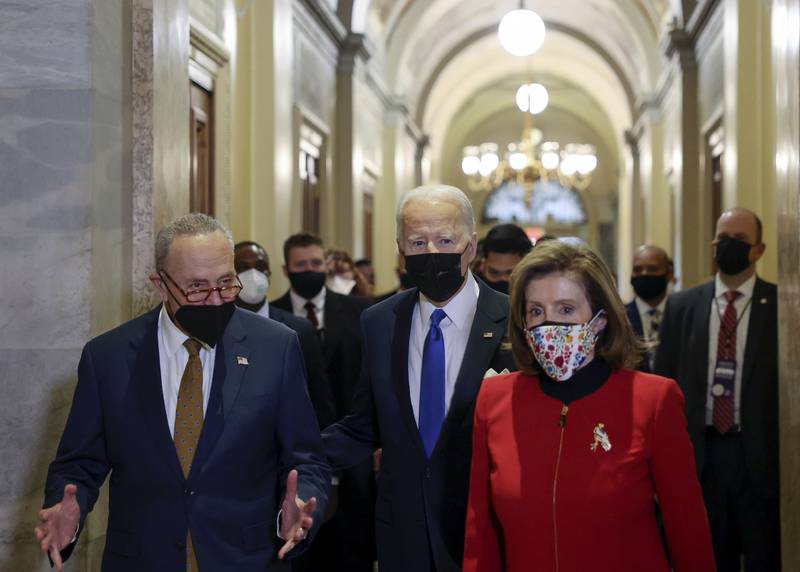 US President Joe Biden with Ms Pelosi and Senate Majority Leader Chuck Schumer in the US Capitol on January 6, 2022. AP
