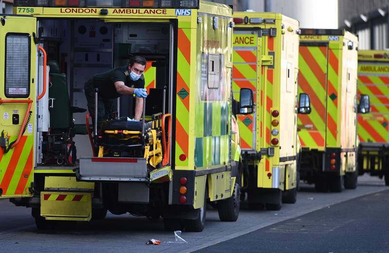 Ambulance staff clean an ambulance outside the Royal London hospital. EPA