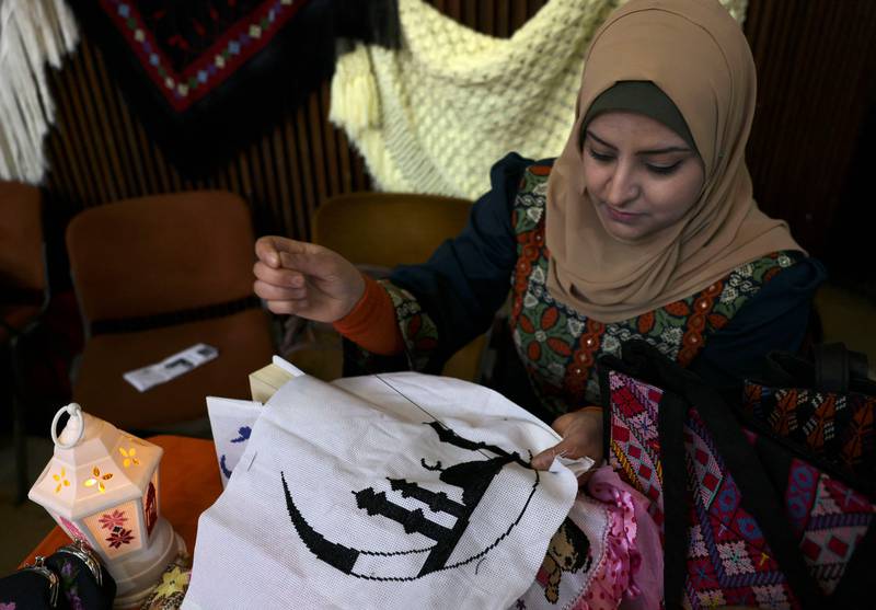 A Palestinian woman prepares Ramadan decorations.  AFP