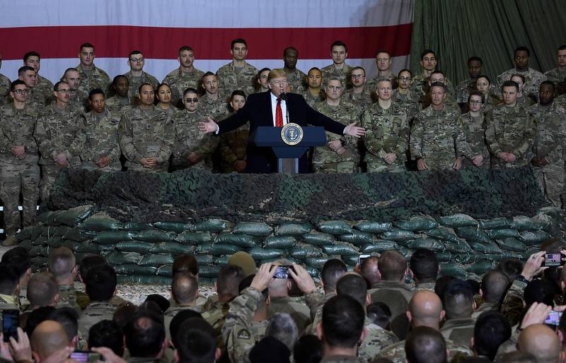 (FILES) In this file photo taken on November 28, 2019 US President Donald Trump speaks to the troops during a surprise Thanksgiving day visit at Bagram Air Field, in Afghanistan. President Donald Trump has shattered norms and niceties on the world stage in his nearly three years in office. Entering an election year, Trump is unlikely to slow down as he seeks what has largely eluded him -- a headline-grabbing victory. / AFP / Olivier Douliery
