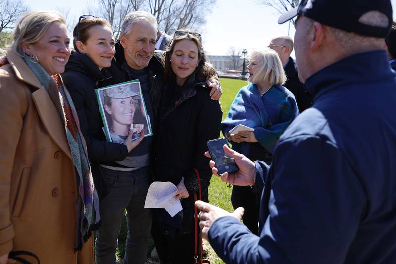 Stewart poses for a photograph with Lauren Grigsby, Charlotte Brock and Melinda Beyer whose friend, Marine Corps veteran Kate Hendricks, died after being exposed to burn pits. AFP
