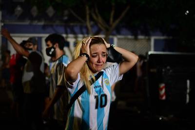 A fan cries as she pays homage to Maradona at Argentinos Juniors' Diego Armando Maradona Stadium  in La Paternal, Buenos Aires, in November. AFP