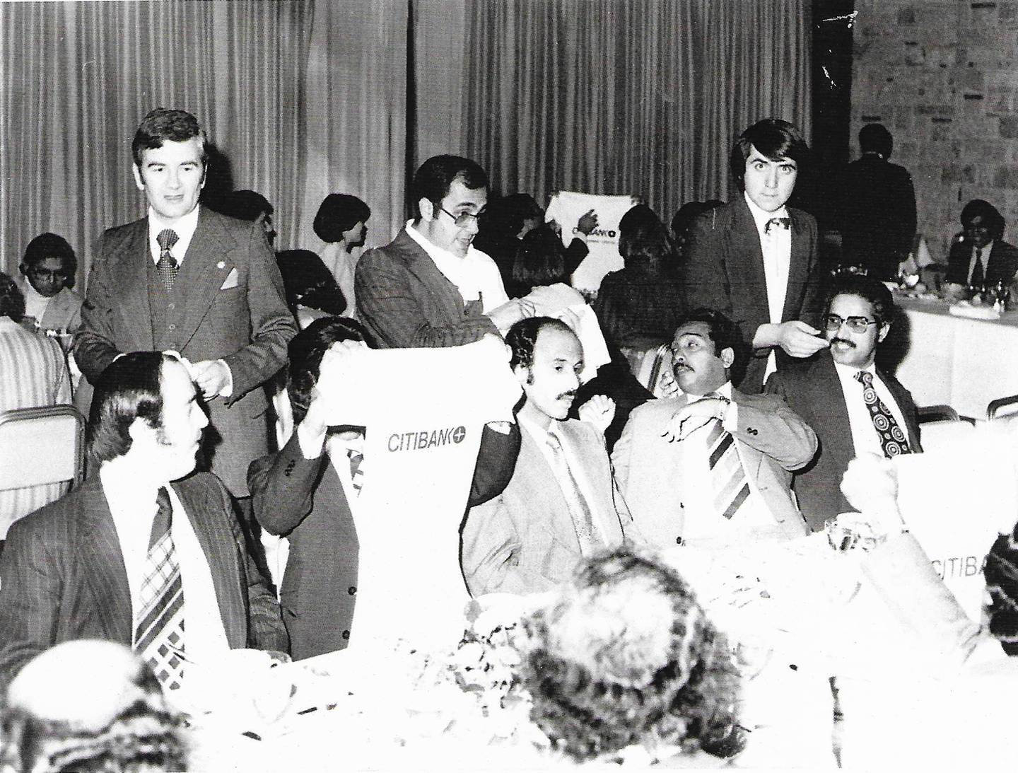 George Kanaan, middle, distributing T-shirts as mementos at a dinner following a session at the MENA training centre of Citibank Athens in 1976. Photo: George Kanaan