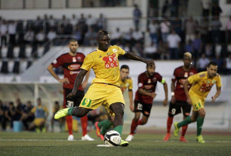 JS Kabylie's Cameroonian striker Albert Ebosse, centre, was hit by a projectile thrown from the stands during his Algerian club's match on Saturday. He later died from the injury. AFP Photo / August 23, 2014 