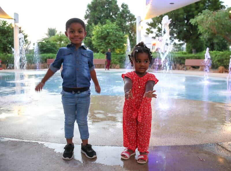 Shafeel Shafi and his sister Shafia enjoy the fountain area.