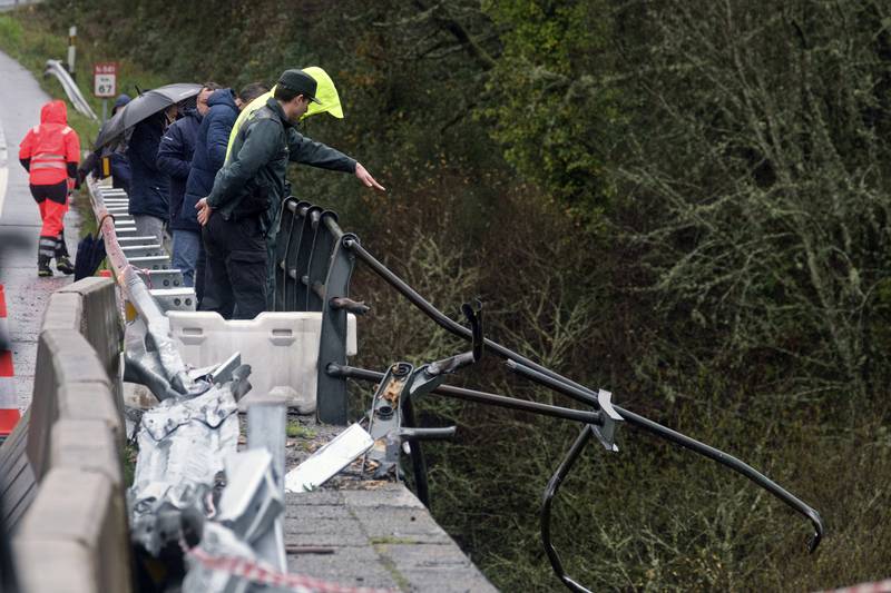 Emergency services were alerted by a motorist who saw a broken railing on the bridge as he drove in heavy rain. AP