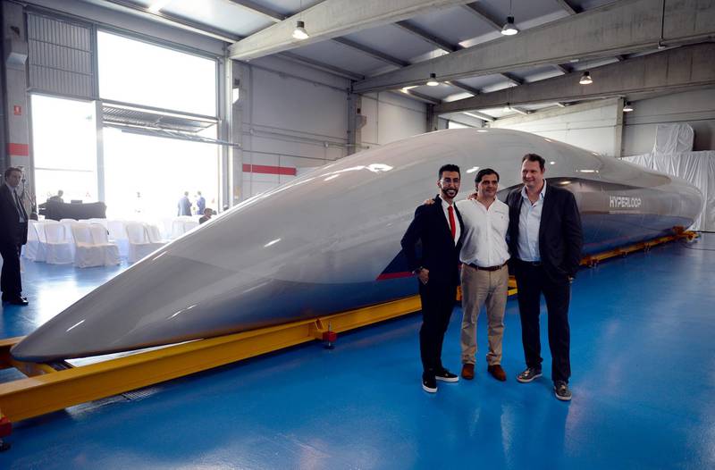 Bibop G. Gresta (L), chairman of Hyperloop Transportation Tech., Airtificial Co-Founder and Chairman, Rafael Contreras (C) and CEO and Co-Founder of Hyperloop Transportation Technologies, Dirk Ahlborn pose next to a full-scale passenger Hyperloop capsule, presented by Hyperloop Transportation Technologies on October 2, 2018 in El Puerto de Santa Maria. A hyperloop is a shuttle that travels on magnetic rails, somewhat like a train, but which runs in a tube with little or no air. In theory, hyperloops could allow travel faster than the speed of sound. Virgin Hyperloop One, backed by British tycoon Richard Branson, has been testing its hyperloop system in Nevada in the United States with speeds reaching 240 miles (386 kilometres) an hour, and is planning three production systems in service by 2021. / AFP / CRISTINA QUICLER
