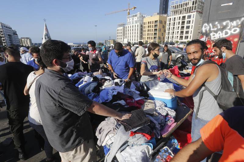 People collect donated items in Martyrs Square to help those affected by the prior days devastating explosion in Beirut. Getty Images