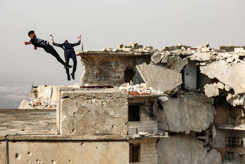 Young Syrian parkour aficionados practise acrobatic moves and backflips in the war-ravaged Syrian town of Ariha in the rebel-held northwestern Idlib province. All photos by AFP
