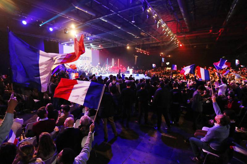 Supporters of French far-right media figure and 2022 presidential candidate Eric Zemmour wave French flags during a rally in Villepinte, near Paris, on December 5. AFP