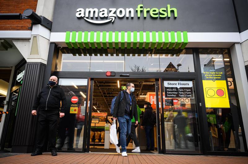 Customers carry their purchases as they leave the UK's first branch of Amazon Fresh. in the Ealing area of London, England. Getty Images