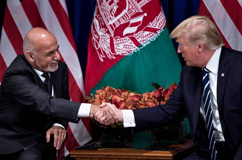 Afghanistan's President Ashraf Ghani and US President Donald Trump shake hands before a meeting at the Palace Hotel during the 72nd United Nations General Assembly on September 21, 2017 in New York City. / AFP PHOTO / Brendan Smialowski