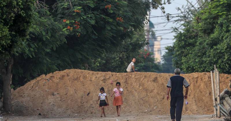 Palestinian children play near the concrete barriers erected to isolate a road leading between Gaza neighborhoods amid the ongoing coronavirus COVID-19 pandemic in Gaza City, Gaza Strip. The Gaza Strip is under a nationwide lockdown from 25 August after the discovery of the first cases of infections with the pandemic SARS-CoV-2 coronavirus which causes the COVID-19 disease.  EPA