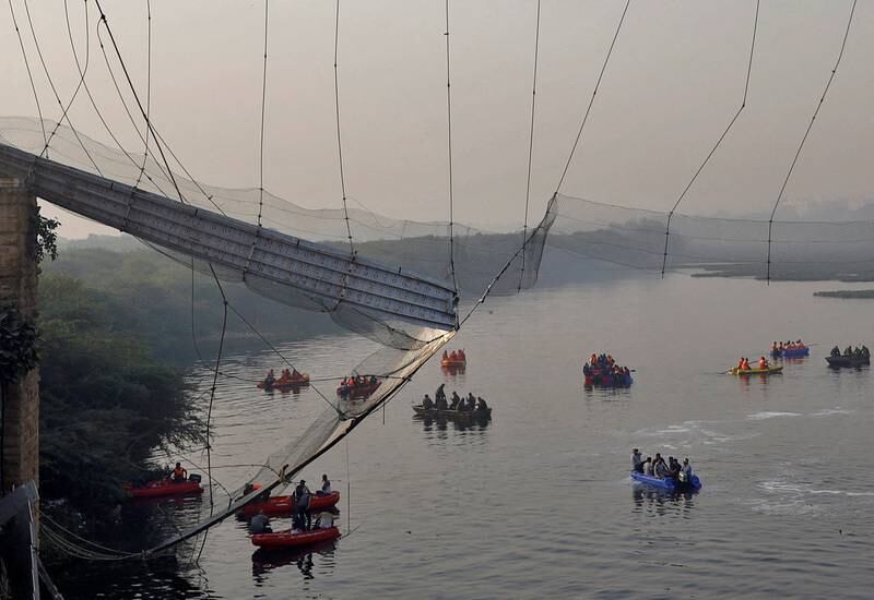 Rescuers search for survivors after a suspension bridge in Morbi town, in the western Indian state of Gujarat, collapsed. Reuters
