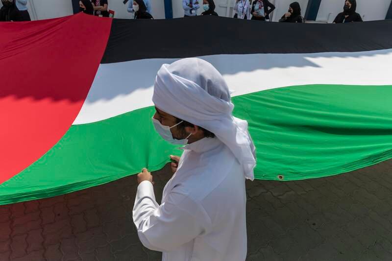 GEMS Al Khaleej International School pupils unveil a giant UAE flag. Antonie Robertson / The National