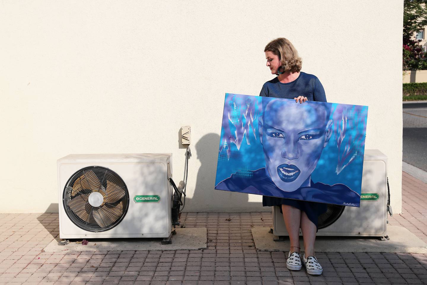 Maddy Butcher, street artist with her art work near her villa in the Springs in Dubai. Pawan Singh/The National 