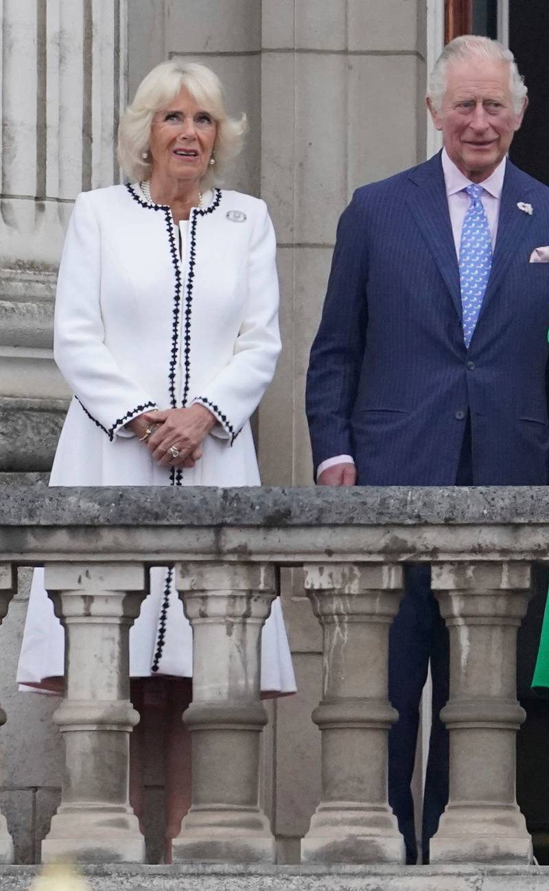 Camilla, Duchess of Cornwall, wearing a white coat over a white dress, with Prince Charles on the balcony of Buckingham Palace on June 5. AP 