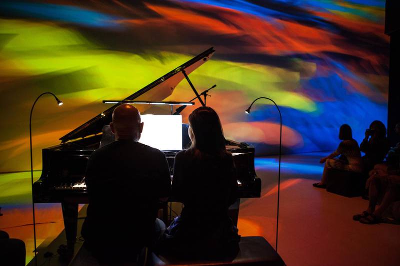 Dennis Russell Davies and Maki Namekawa play the piano while Cori Olan visuals are thrown up behind them in the immersive multimedia spectacular that is Pianographique: Works for two pianos. Abu Dhabi Festival