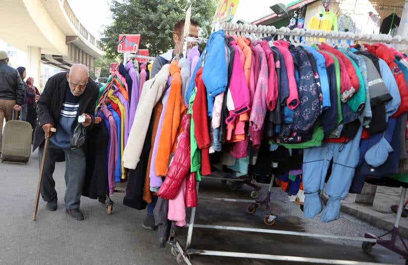 A man walks past an outdoor garments market at Cairo's Bulaq district. EPA