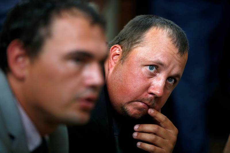 Farmers Willem Oosthuizen and Theo Martins react after being sentenced for kidnap, assault and attempted murder, in connection with forcing a man into a coffin, in Middelburg, South Africa, October 27, 2017. REUTERS/Siphiwe Sibeko