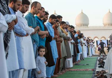 Worshippers perform morning prayers on the first day of Eid Al Fitr at the Sheikh Zayed Grand Mosque in Abu Dhabi. Leslie Pableo for The National