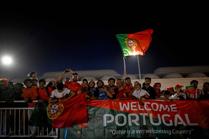 Portugal's supporters cheer as the team arrives at their hotel in Al Shamal, Doha. AFP
