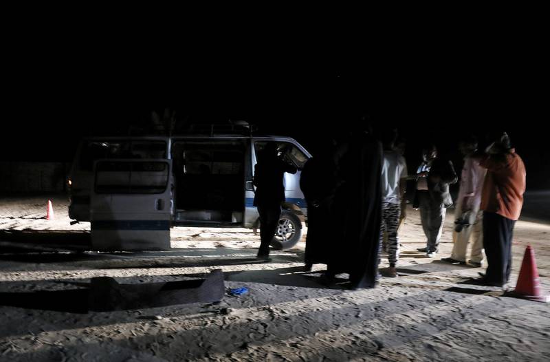 Policemen stand beside the microbus which carried the Coptic Christians when gunmen opened fire in Minya. Reuters