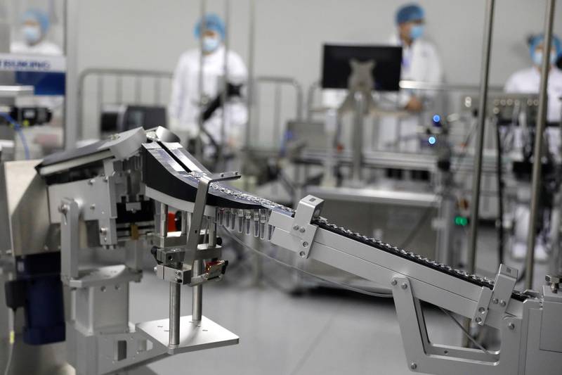 Doses of the Sinopharm vaccine pass along the production line. Reuters