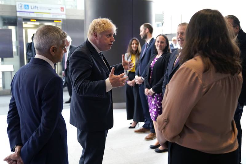 Boris Johnson speaks with staff at the station. PA