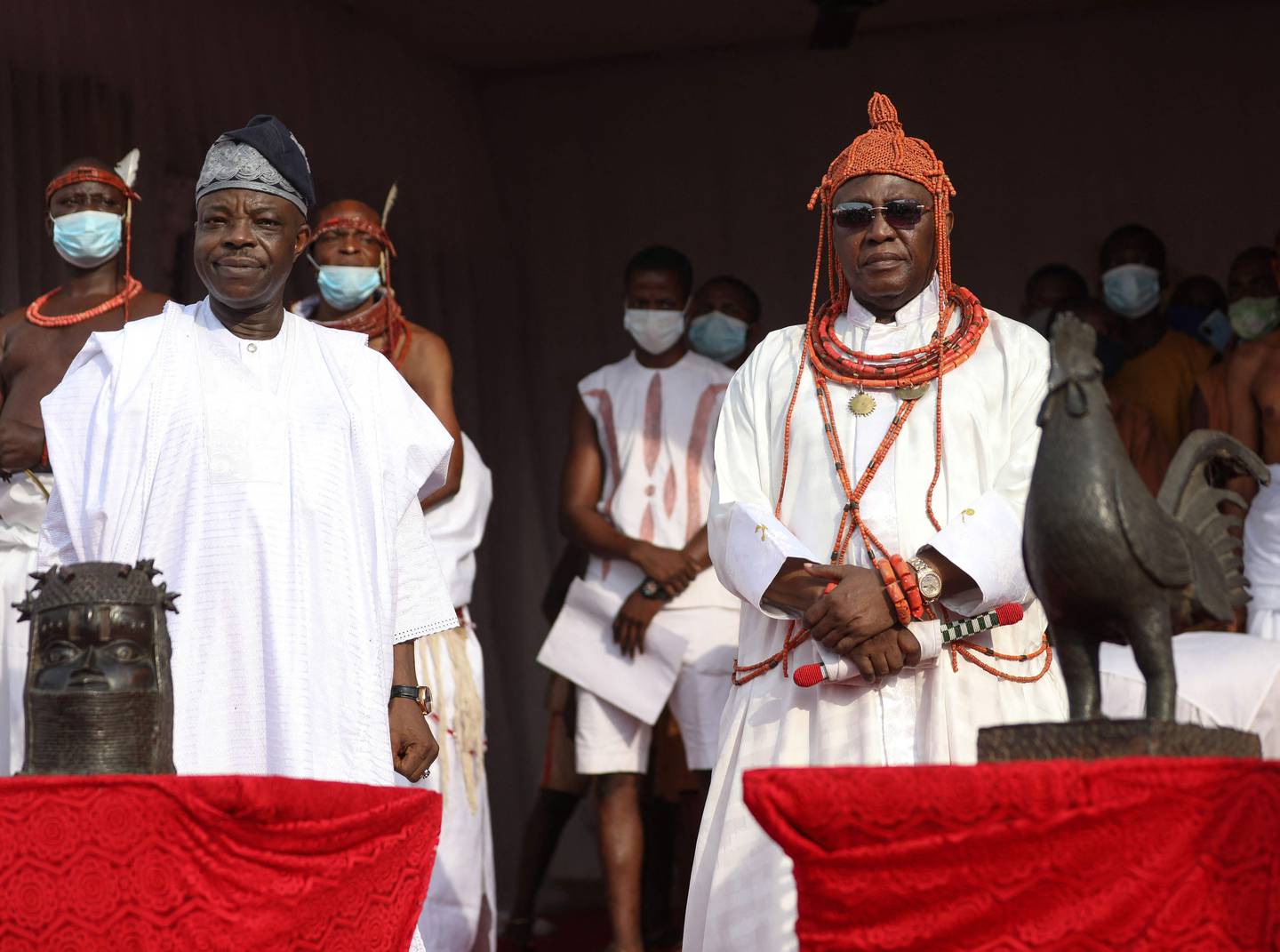 King Ewuare II, known as the Oba of Benin, right, and Nigerian High Commissioner to the UK, Sarafadeen Tunji Isola, receive the repatriated artefacts. AFP
