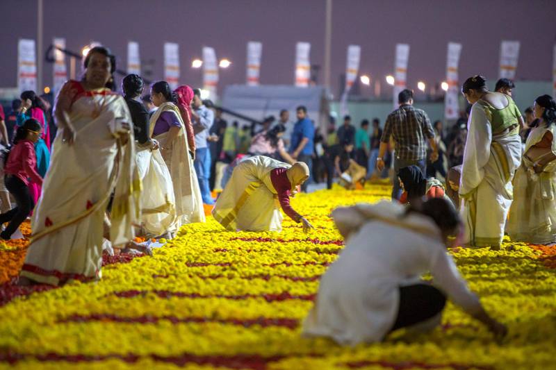 Dubai, United Arab Emirates- Thousands of volunteers laying out fresh flowers at the worlds largest fresh flower carpet with the theme of Tolerance to highlight UAE as a global capital  for tolerance at Dubai Festival City.  Leslie Pableo for The National
