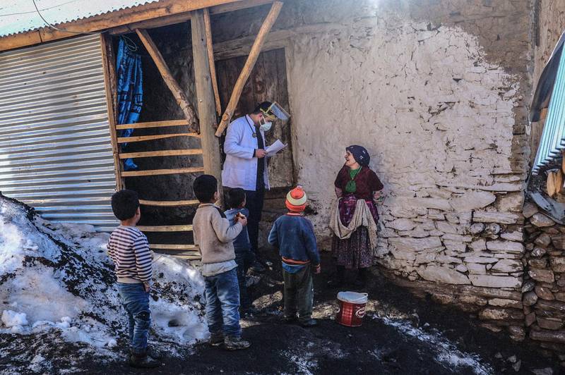 Doctor Akay Kaya from Bahcesaray public hospital vaccination team speaks with a Kurdish woman in the village of Guneyyamac in eastern Turkey. AFP