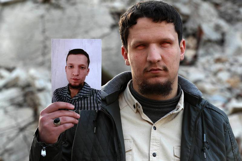 Abu Anas, 26, reportedly blinded in the aftermath of government shelling, poses for a picture in the rebel-held northwestern city of Idlib, while holding a photograph of himself when he was 16. Originally from the town of Saqba in the countryside of the capital Damascus, Abu Anas was displaced from his home in 2018. He was then injured during artillery shelling in 2020 and lost his eyesight. He was recently married and has no children. He is currently a 4th year student in law and Sharia at Idlib University. AFP