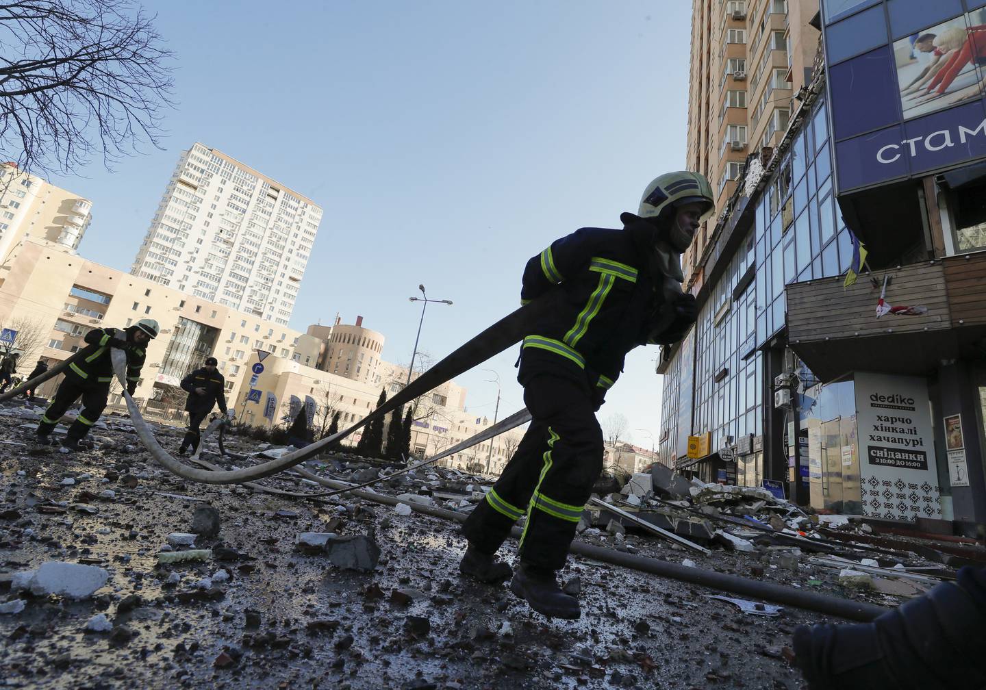 Ukrainian firefighters at a high-rise apartment block in Kiev which was hit by Russian shelling.  EPA