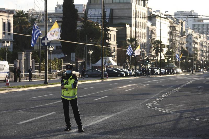 A policewoman guards a closed avenue ahead of the Mass by Pope Francis in the Greek capital. AP Photo