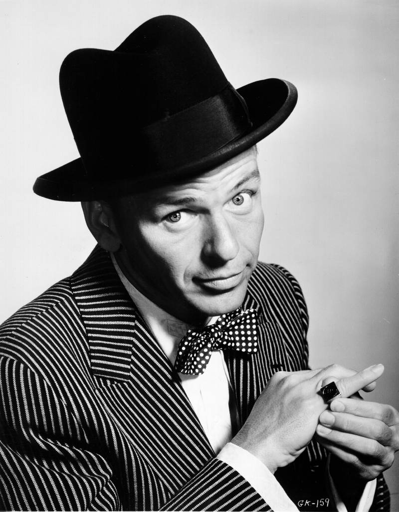 CIRCA 1950: Pop singer Frank Sinatra poses for a portrait sporting a hat and bow tie and showing off a ring on his pinky in circa 1950. (Photo by Michael Ochs Archives/Getty Images)  