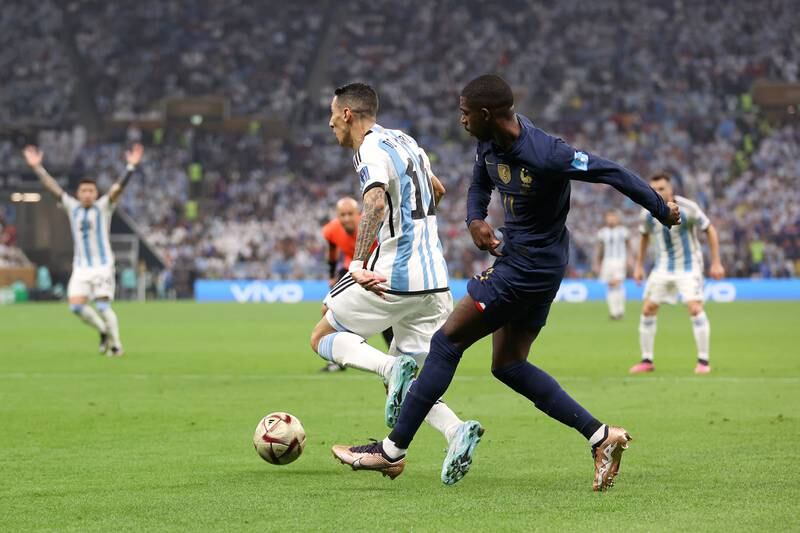 Argentina attacker Angel Di Maria earns a penalty after going down under the challenge of France's Ousmane Dembele. Getty