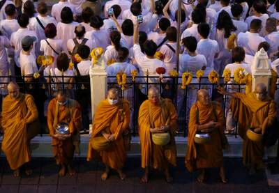 Thai Buddhist monks line up for morning alms in Bangkok. EPA