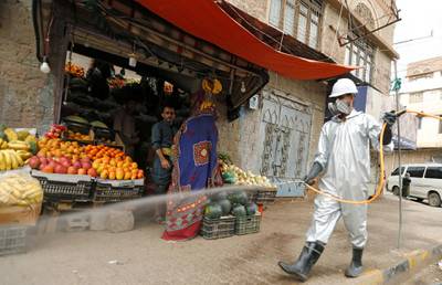 A health worker wearing a protecitve suit disinfects a market amid concerns of the spread of the coronavirus disease (COVID-19), in Sanaa, Yemen April 28, 2020. REUTERS/Khaled Abdullah