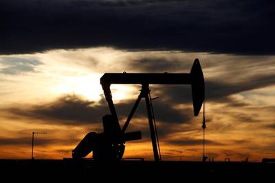 FILE PHOTO: The sun sets behind a crude oil pump jack on a drill pad in the Permian Basin in Loving County, Texas, U.S. November 24, 2019. .  REUTERS/Angus Mordant/File Photo