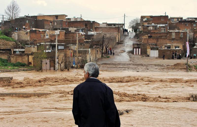 A  man watches as floodwaters hit the city of Khorramabad in the western province of Lorestan, Iran.  AP