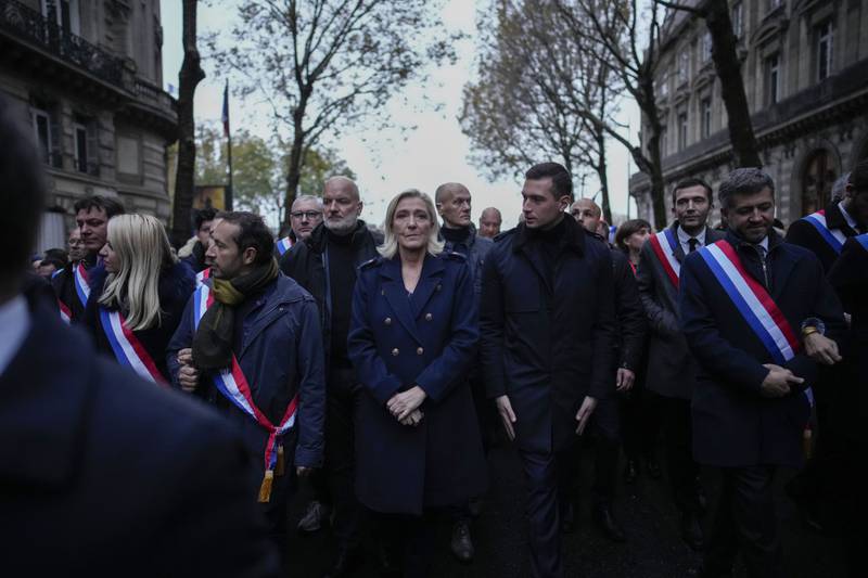 Marine Le Pen, centre, joins a march against anti-Semitism in Paris. AP