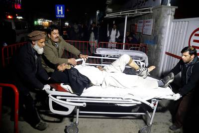 epa07283684 Afghan health workers carry an injured man to the emergency hospital after a truck bomb blast targeted Green Village camp belong to foreigners in capital Kabul, Afghanistan, 14 January 2019. According to the initial reports, at least 10 person killed and 44 others are injured.  EPA/JAWAD JALALI