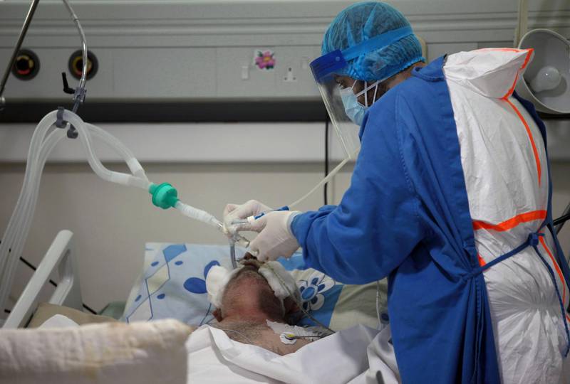 A medical staff member assists a patient suffering from coronavirus, in an intensive care unit at Rafik Hariri University Hospital, in Beirut, Lebanon. Reuters
