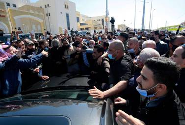 An angry crowd gathers outside Al Hussein Al Salt Hospital in Al Salt, Jordan after several Covid-19 patients died there on March 13, 2021 due to a shortage of oxygen supplies. AP